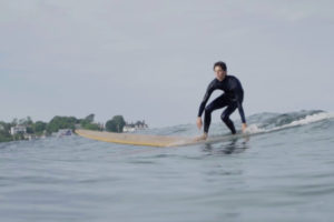 Surfer on Grain Surfboards board.